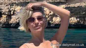 Julianne Hough goes topless as she shows off her toned physique aboard a boat in Ibiza