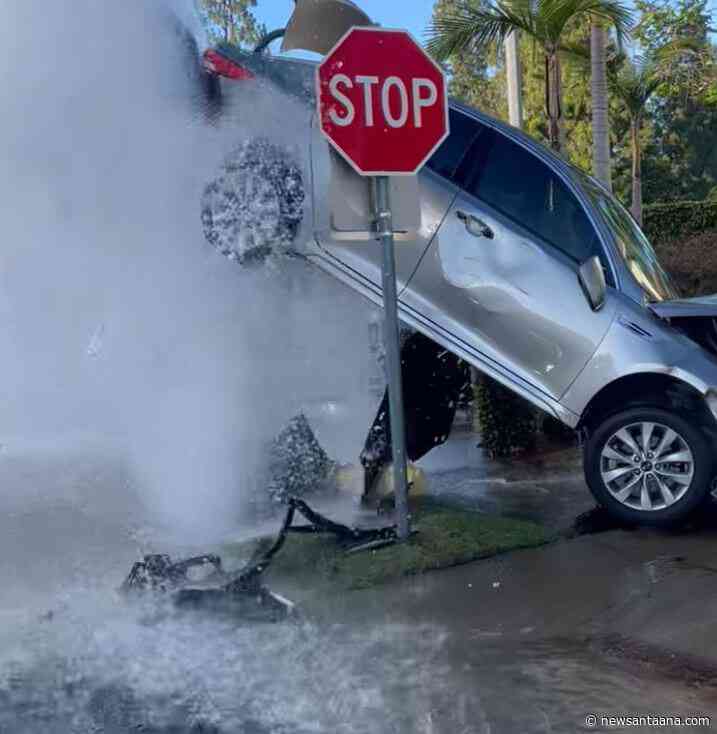 Orange County collision leaves a car atop a sheared fire hydrant gushing water