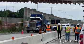 Part of QEW closed after dump truck with raised bin crashes into bridge overpass