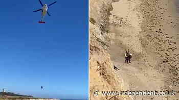 Stranded kite surfer rescued from beach after spelling out message with rocks