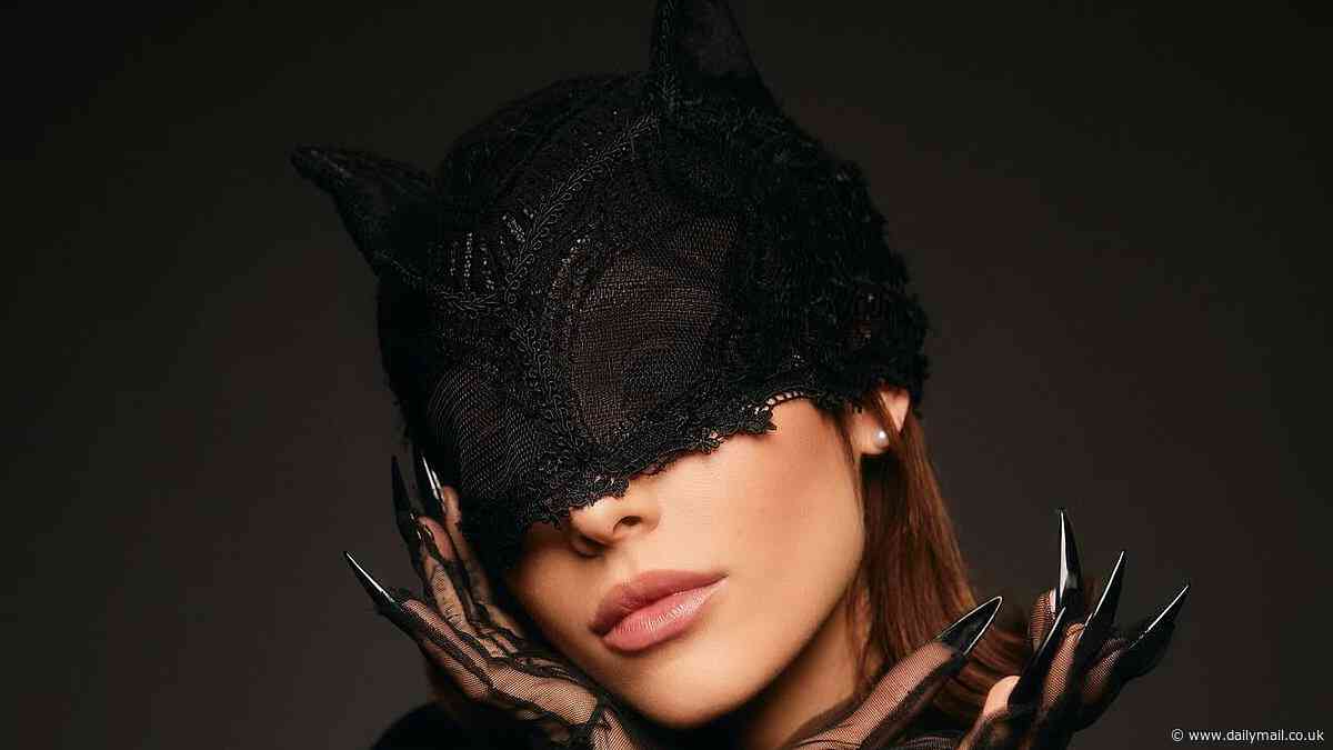 Ariana Grande glams up in her sexy leather Catwoman costume for behind-the-scenes footage from latest The Boy Is Mine music video