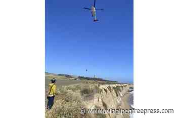 Kite surfer rescued from remote California beach rescued after making ‘HELP’ sign with rocks