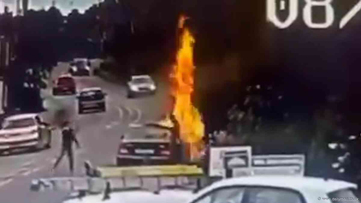 Hunt for the speed camera arsonists: Police chase pair who doused pole in flammable liquid then set it on fire before fleeing