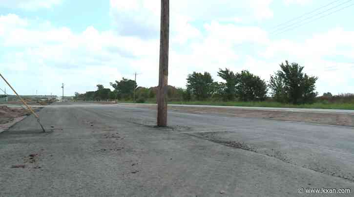 Why are there poles in the middle of a road near FM 973?