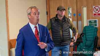 Nigel Farage is seen flanked by security guards just hours after being attacked on open-top bus - as he tells loyal supporters he will 'not surrender'