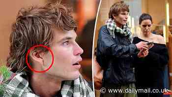 Aussie catwalk star Jordan Barrett reveals prominent scar on his ear as he steps out in London with fellow model Tahnee Atkinson