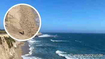 Surfer am verlassenen Strand in Not – Hilferuf im Sand rettet ihm das Leben