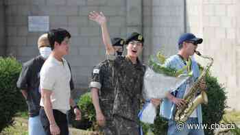 BTS star Jin celebrates in uniform after completing mandatory military service