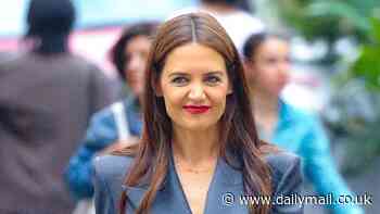 Katie Holmes is the epitome of chic in a stylish navy suit and red stilettos as she strolls through Soho