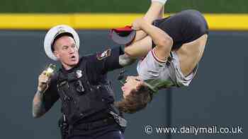 Reds fan is tasered and tackled by police after storming the field in Cincinnati and performing a flawless back flip