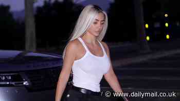 Kim Kardashian goes braless in a strappy white T-shirt and struts her stuff in leather knee-high boots as she steps out in Los Angeles