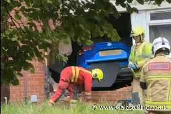 Man taken to hospital after car crashes into flats