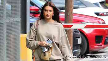 Sasha Attwood cuts a casual figure in a beige tracksuit as she steps out solo in Cheshire while boyfriend Jack Grealish parties in Dubai after missing out on Euros squad