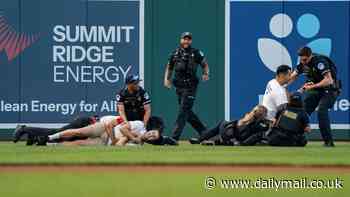 Annual Congressional Baseball Game descends into chaos after climate change protestors storm the field in Washington DC - before being tackled to the ground and arrested by cops