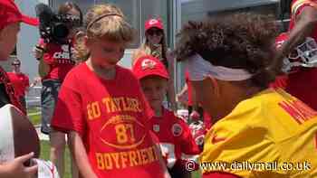 Adorable moment Travis Kelce and Patrick Mahomes make young cancer survivor's day... as superstar Chiefs pair pose for photos - and sign a shirt hailing 'Taylor Swift's boyfriend'