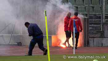 Serbia training session halted as pyro-wielding fans clash with police just days before England match... after security officials rule fixture 'high risk' over hooliganism fears