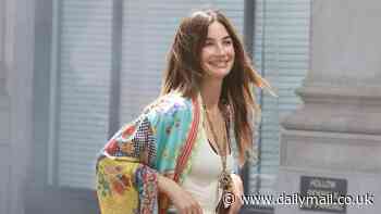 Lily Aldridge is boho chic in 1970s-inspired look with a colorful robe and tight denim jeans during Manhattan photoshoot