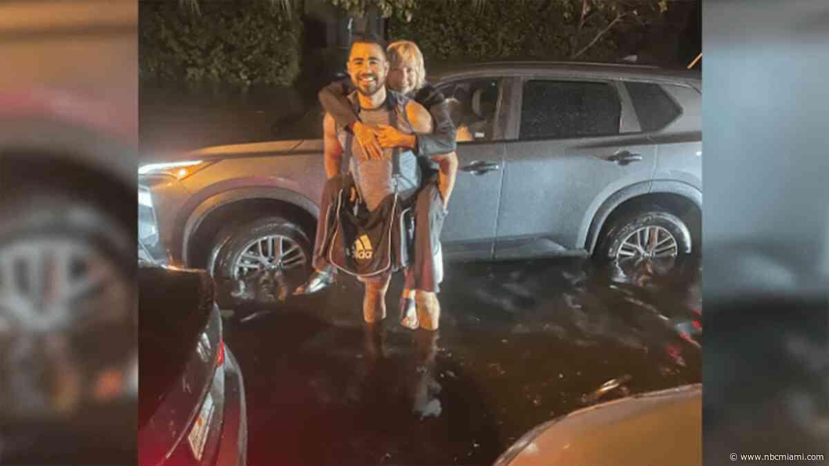 ‘A hero': Story behind photo of stranger saving woman stranded in South Florida floodwaters