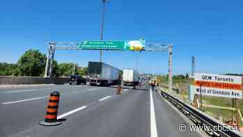 QEW partially closed in Niagara Falls after dump truck hits overhead traffic sign: police