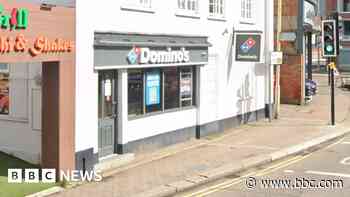 Man dies after car crashes into Domino's takeaway