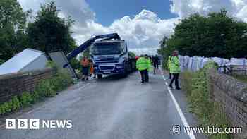 Main road closed after HGV enters canal