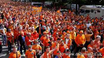 Dutch fans line the streets of Hamburg in their thousands ahead of their Euro 2024 opener vs Poland... as 'CRAZY' sea of orange goes viral