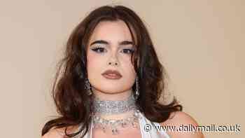 Euphoria star Barbie Ferreira dazzles in a plunging silver gown displaying her cleavage rose tattoo as she attends Swarovski's Masters Of Light exhibition in Milan