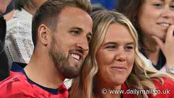 Harry Kane's WAG embrace: England skipper cuddles his wife after a nervy win over Serbia - with the Three Lions' players glamorous partners cheering them onto victory