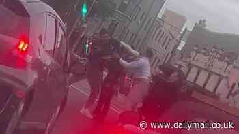 Wild moment woman slaps man across the head as she tries to break up brawl in the middle of the street in Newtown