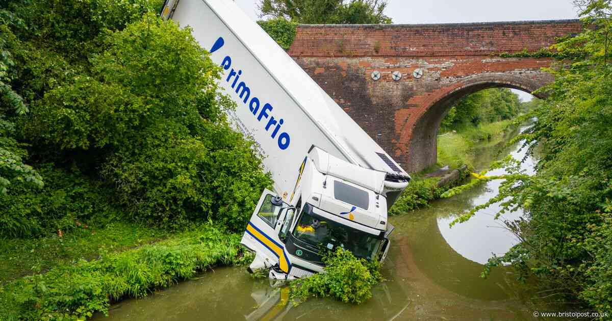 Lorry plunges into canal after crashing off bridge