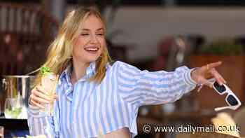 Sophie Turner flashes her toned torso in a chic striped co-ord as she sips on cocktails during al fresco lunch in the south of France