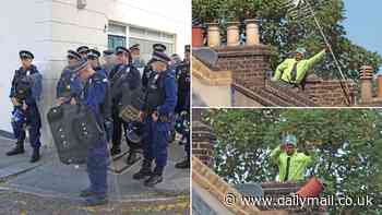 Police with riot shields in tense stand-off with man throwing chimney pots and TV aerials from a roof in west London