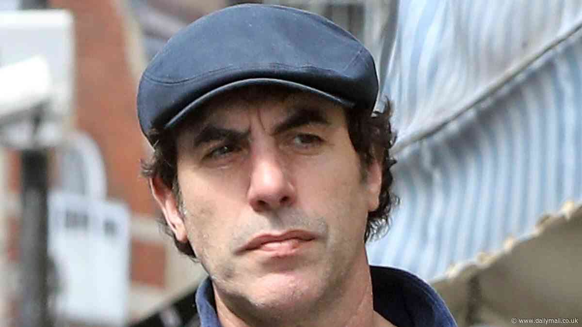 Is Sacha Baron Cohen wearing his wedding ring again? Actor is seen with what looks like a 'band' on his wedding finger as he steps out in London following split from Isla Fisher