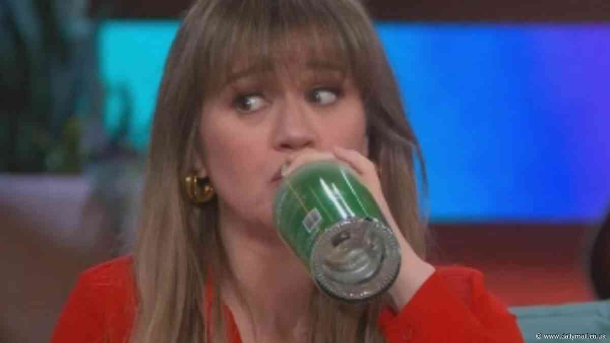 Kelly Clarkson downs RUM from the bottle on live TV - as she shows off her slimmed down figure in a mini skirt: 'Oh that is dangerous!'