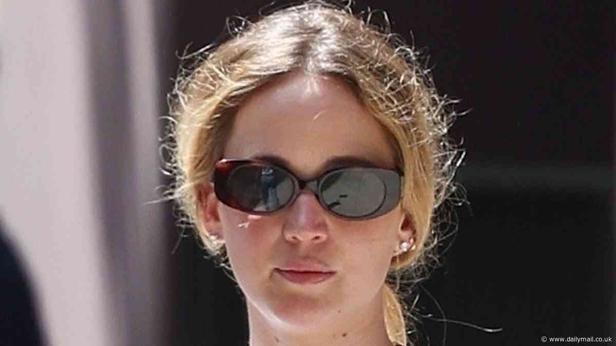 Jennifer Lawrence wears a Mickey Mouse shirt and black miniskirt as she enjoys family stroll with son Cy, two, and husband Cooke Maroney in NYC