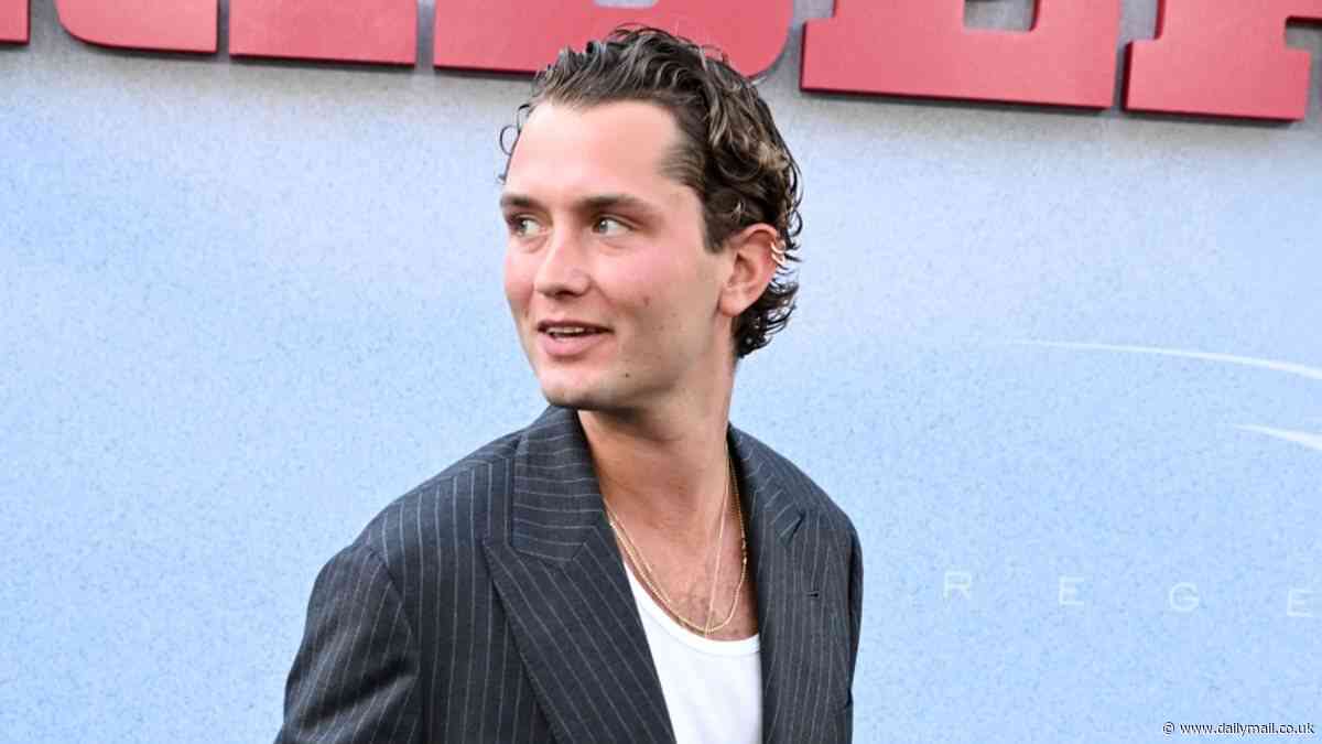 Jude Law's lookalike son Rafferty rocks up to The Bikeriders' LA premiere in a relaxed pinstripe suit and low scoop T-shirt with gelled hair in look reminiscent of heartthrob's style
