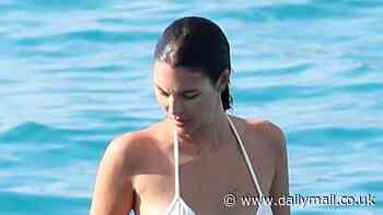Leonardo DiCaprio's girlfriend Vittoria Ceretti shows off her incredible figure in a tiny white bikini as she enjoys a boat trip in Spain