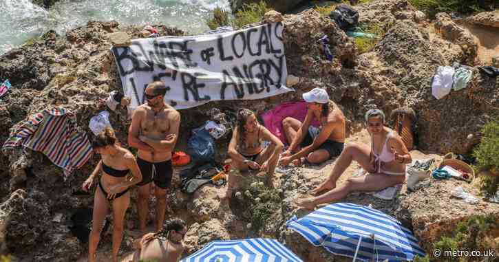 Furious locals block ‘bad tourists’ from idyllic beach on Spanish party island