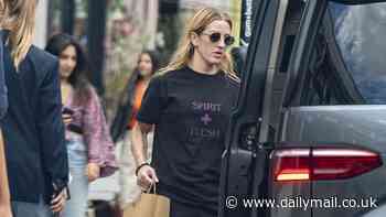 Ellie Goulding cuts a casual figure in a black slogan T-shirt and jogging bottoms as she runs errands in London
