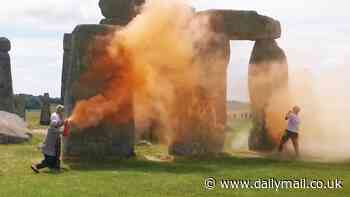 Just Stop Oil spray Stonehenge with orange paint as heroic passer-by steps in to try to drag them away