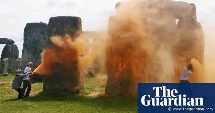 Activists spray Stonehenge with orange powder paint ahead of summer solstice – video