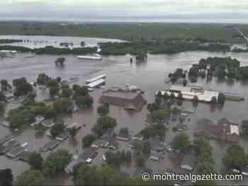 Helicopters scramble to rescue people in flooded Iowa town while much of U.S. toils again in heat