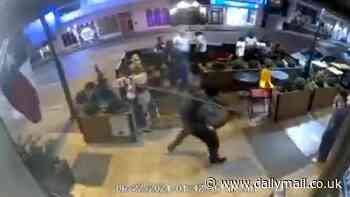 Shocking moment random man smacks bar patron over the back of the head with a huge stick