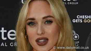 Pregnant Jorgie Porter cradles her baby bump while wearing a white minidress as she joins glam Charlotte Dawson at clinic launch