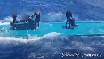 Moment bungling team of drug smugglers are saved from the top of their sinking Colombian Narco sub 280 miles off the Spanish coast - before cops arrest them