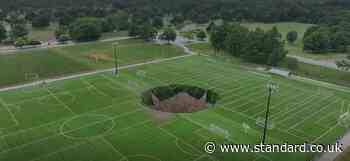 Security cam captures moment giant sinkhole swallows football pitch in Illinois