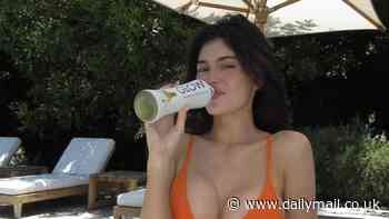 Kylie Jenner stuns in an itty-bitty orange bikini as she promotes drink poolside