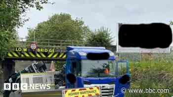 Road shut after lorry toppled in bridge strike
