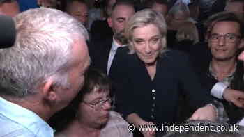 French far-right leader Marine Le Pen swarmed by supporters after lead in first round of election