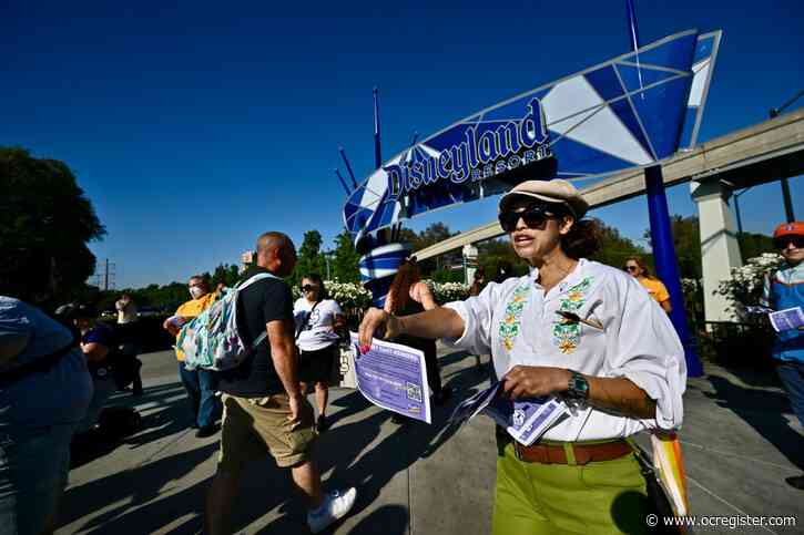 Disneyland union hands out Mickey Mouse raised fist buttons to theme park visitors